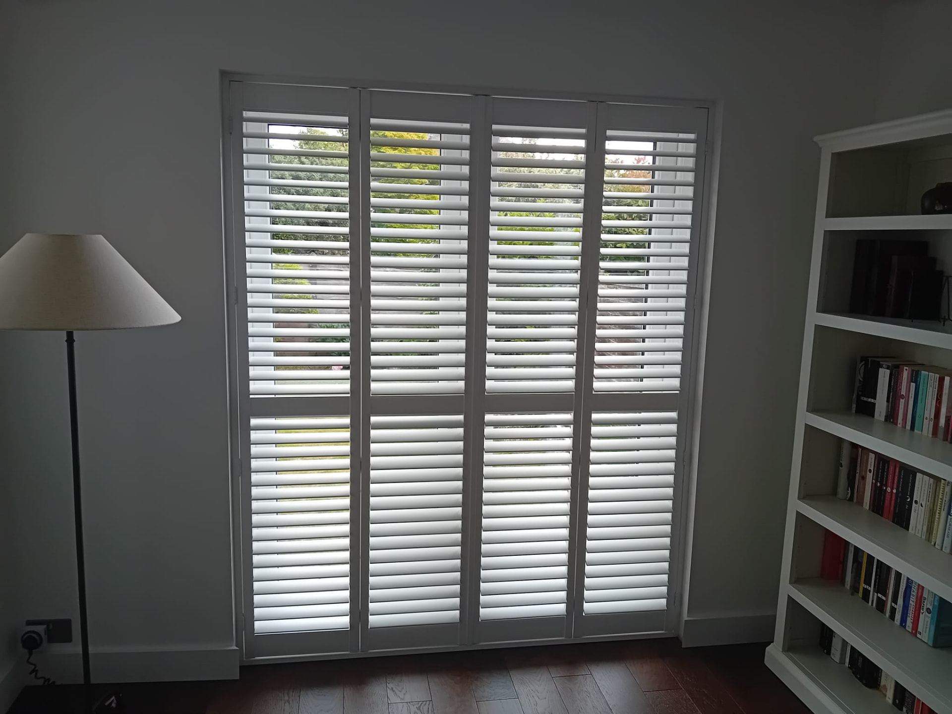 Tier-on-tier white shutters fitted to patio doors