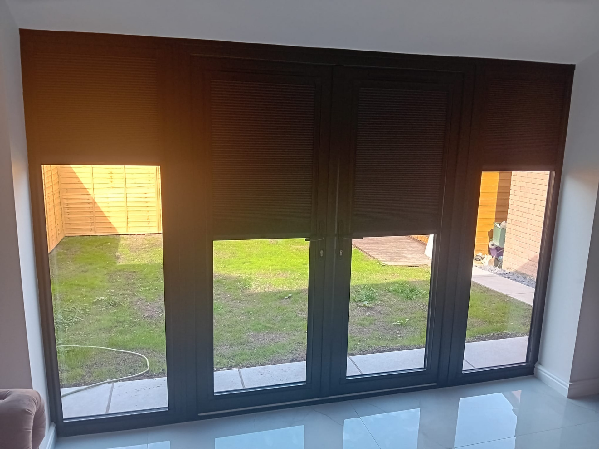 Black perfect fit pleated blinds fitted to patio doors and side windows