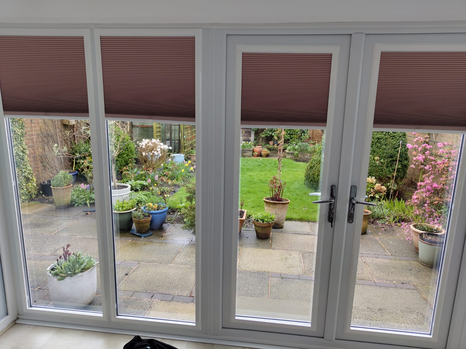 Softcell perfect fit blinds on French doors overlooking a garden