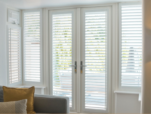 Perfect fit shutters fitted to French doors in a Manchester living room