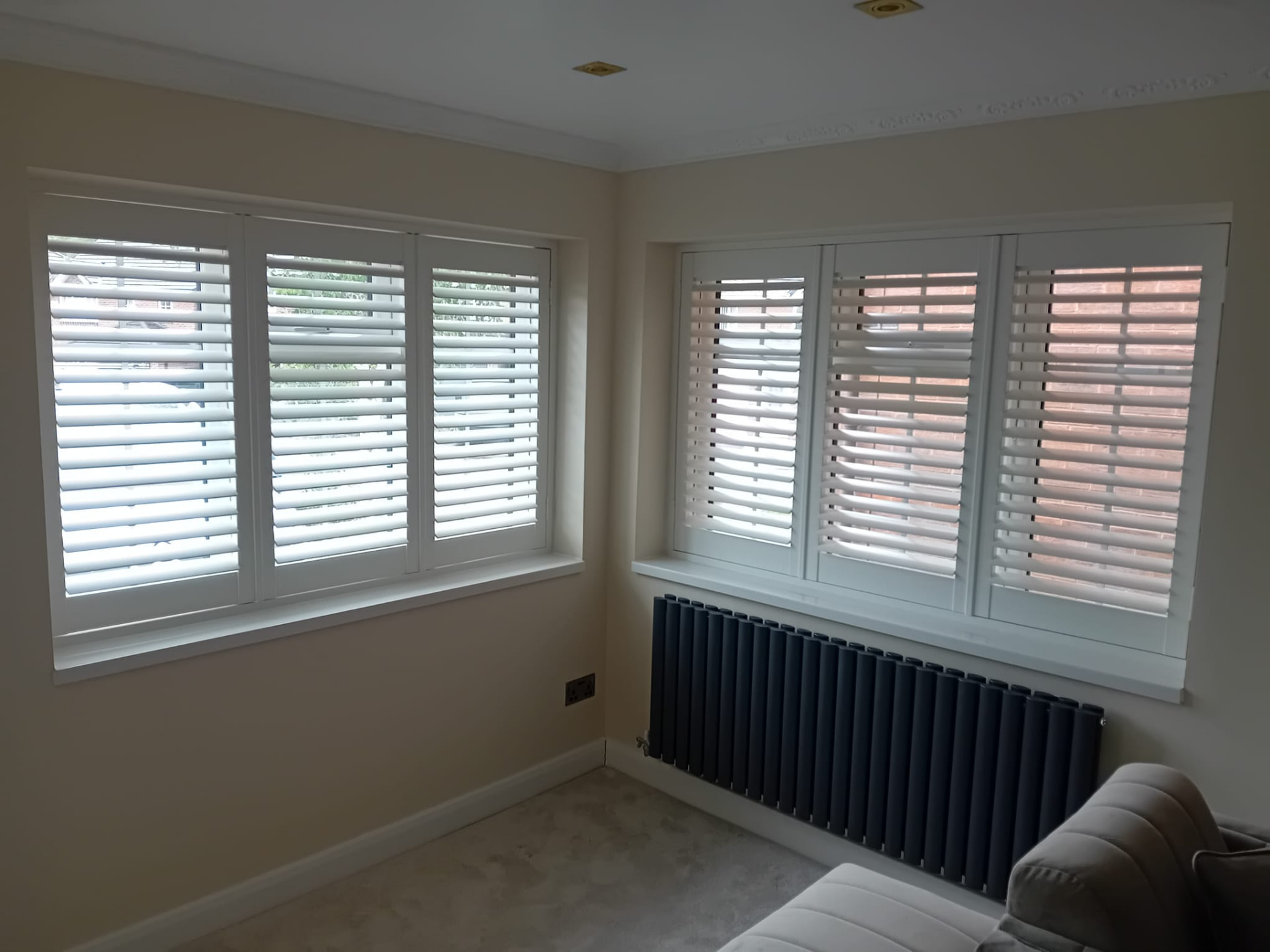 White fauxwood shutters on two lounge windows