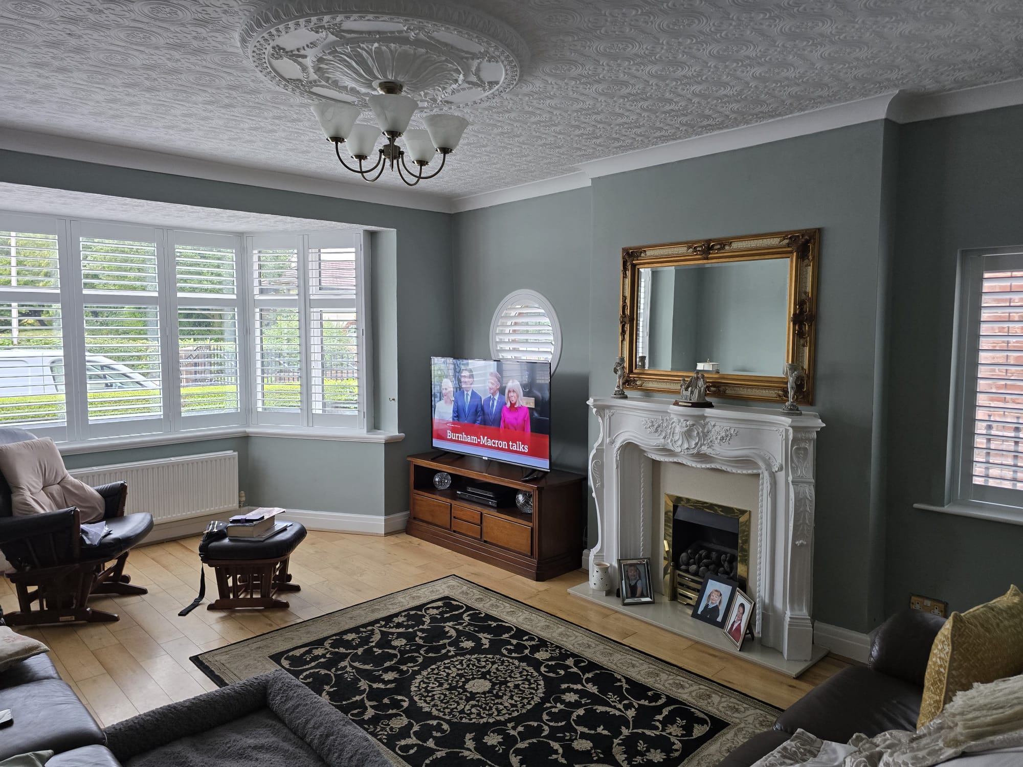 Full living room view with white plantation shutters in a Manchester home